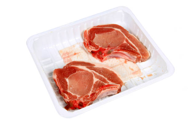 istock Raw Pork chops in a packing dish on a white background 1224703311