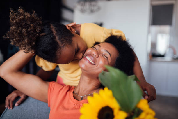 Beautiful little girl giving her mother a mother's day present