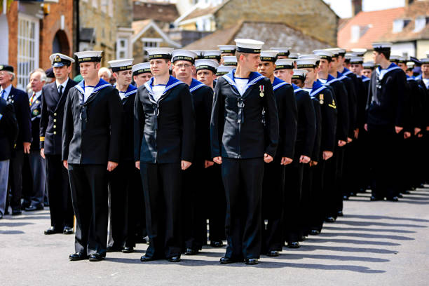 uk armed forces day parade royal navy sailors from hms heron marching through sherborne dorset, uk - saluting sailor armed forces men photos et images de collection