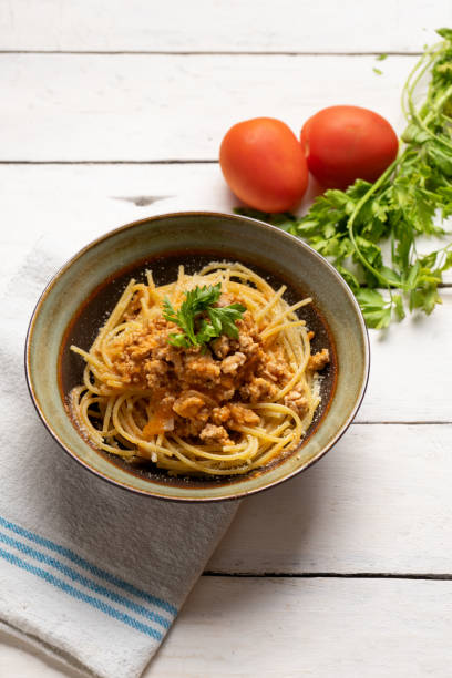 istock Spaghetti bolognese with parmesan cheese on white background 1224704985