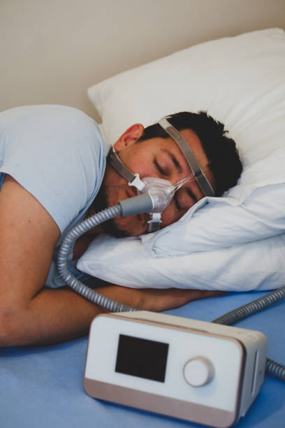 istock man wearing under the nose nasal mask ( CPAP mask ) and using CPAP machine for sleeping smoothly 1224705008