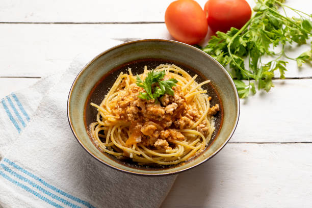 istock Spaghetti bolognese with parmesan cheese on white background 1224705184
