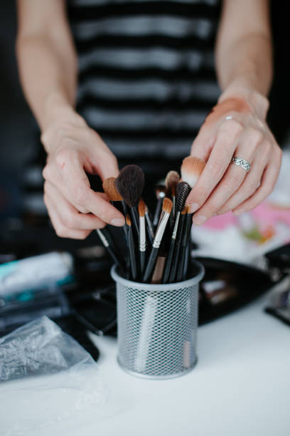 istock Make-up artist applying bright base color eyeshadow, close up. 1224705265