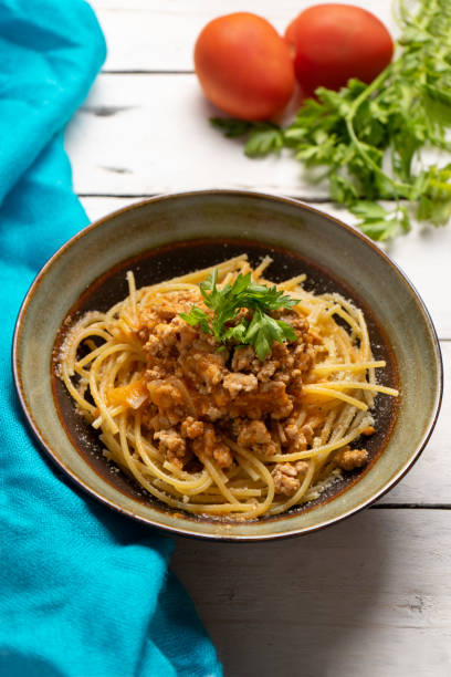 istock Spaghetti bolognese with parmesan cheese on white background 1224706208
