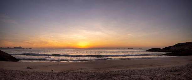 istock Crack of dawn just before sunrise at the Arpoador Devil's beach in Rio de Janeiro 1224706488