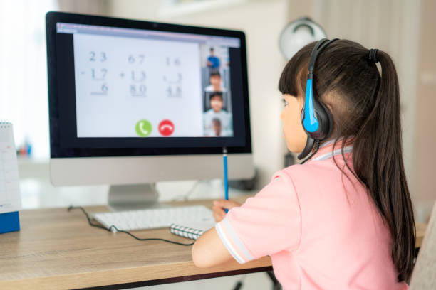 istock Asian girl student video conference e-learning with teacher and classmates on computer in living room at home. Homeschooling and distance learning ,online ,education and internet. 1224707135