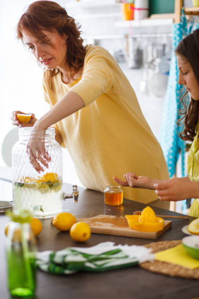 istock Woman adding lemons to lemonade 1224712951