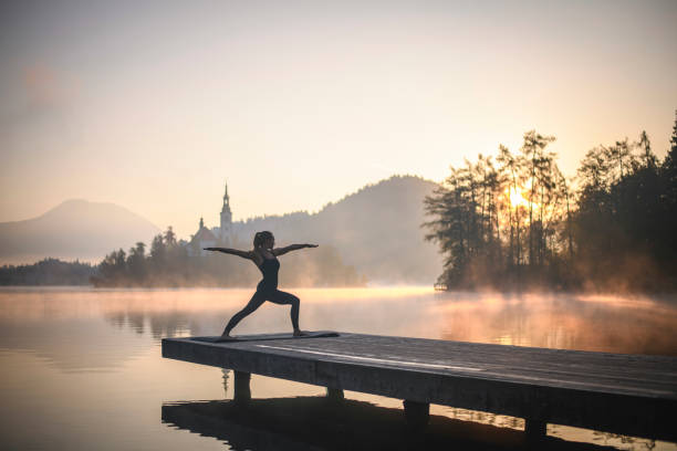 istock Yoga at Dawn on Pier Overlooking Lake Bled 1224713005