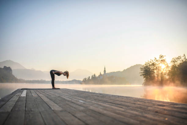 istock Woman Standing in Half Forward Bend Position at Lake Bled 1224713006