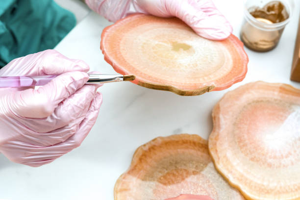 istock Creativity and craft. A young girl creates coasters from resin. Gift wrapping. Decorative packaging. Idea for business. Remote work, work at home. Art coasters. 1224713590