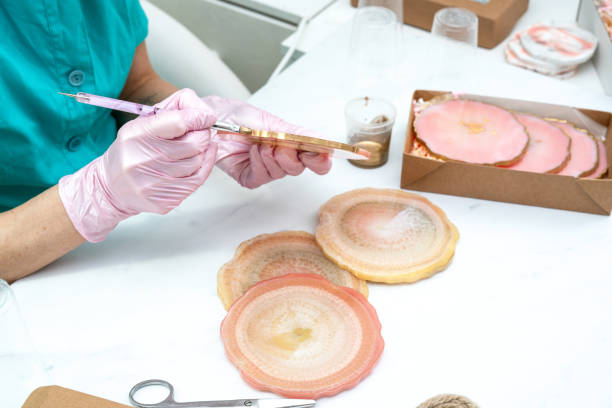 istock Creativity and craft. A young girl creates coasters from resin. Gift wrapping. Decorative packaging. Idea for business. Remote work, work at home. Art coasters. 1224713595