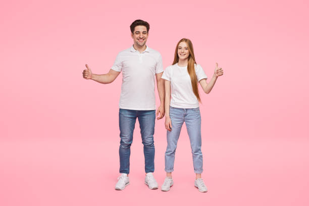 istock Cheerful young couple showing thumbs up 1224713788