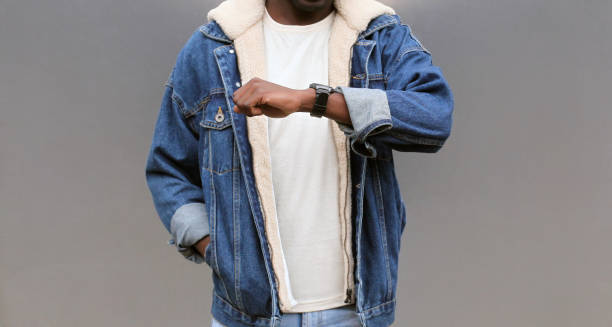 istock Close up african man looking at smart watch using voice assistant or takes calling on gray background 1224714088