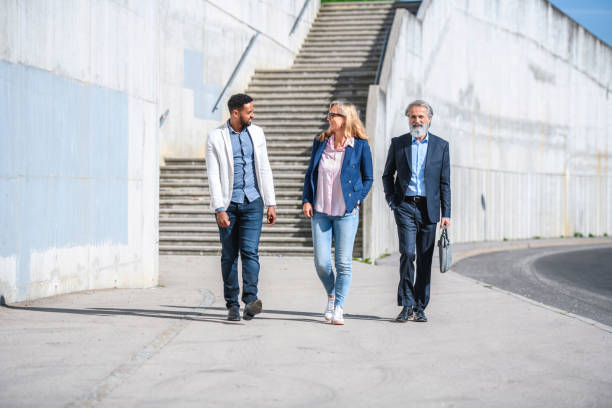 Business Colleagues Walking in Sunny Urban Location
