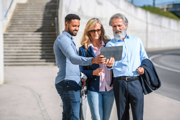 istock Businesspeople Stopping to Take Selfie on Digital Tablet 1224714108