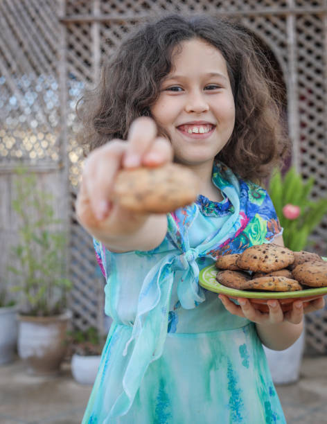 Try my cookies! The girl made delicious cookies. moroccan girl stock pictures, royalty-free photos & images