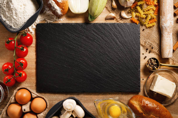 istock tip view board and vegetables with spices on kitchen table. Cooking classes concept. with copy space 1224717688