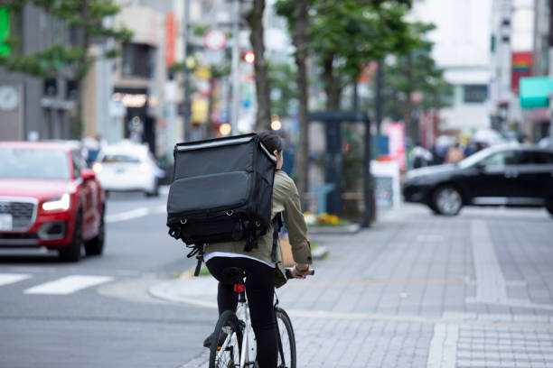istock Young woman doing luggage delivery by bicycle 1224717860