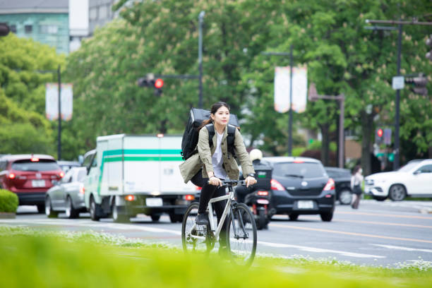 istock Young woman doing luggage delivery by bicycle 1224717888