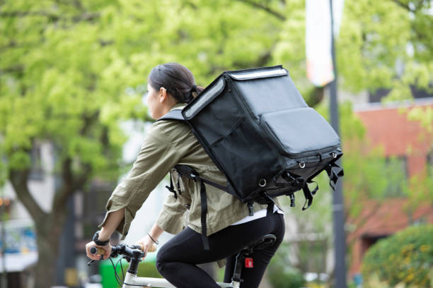 istock Young woman doing luggage delivery by bicycle 1224717905