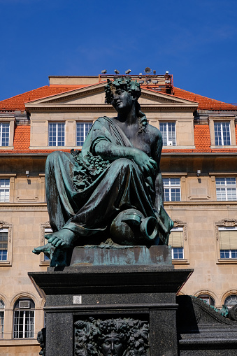Statue in the middle of the Main Square of Graz and the Uhrturm