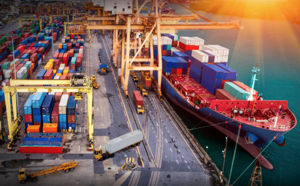istock Logistics and transportation of Container Cargo ship and Cargo plane with working crane bridge in shipyard at sunrise, logistic import export and transport industry background 1224725294
