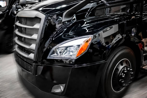 istock Stylish black big rig shiny big rig semi truck with light reflection on the surface 1224729164