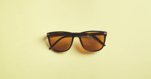 istock Stylish sunglasses on yellow background. 1224734595