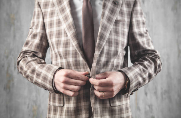 istock Man fastening buttons on suit. Fashion 1224734596