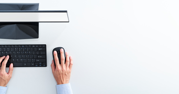 Businessman clicking mouse on white background.