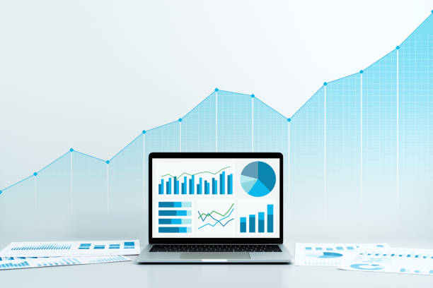 analyzing business data and growth. laptop and reports. - spreadsheet financial figures computer computer monitor imagens e fotografias de stock