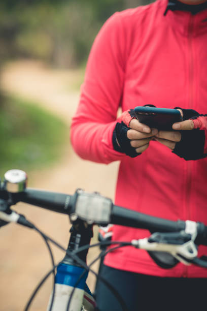 istock Cyclist use smartphone for navigation when riding mountain bike on forest trail 1224739421