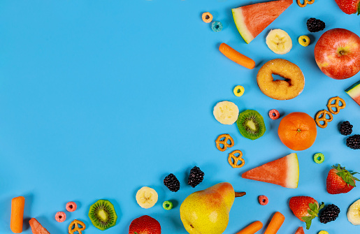 Falling or flying fruits , selective focus. The selective focus technique  give more realism to the movement and a 3D effect. Large variety of fruits   leave an empty space in the middle, copy space in the shape of heart. 