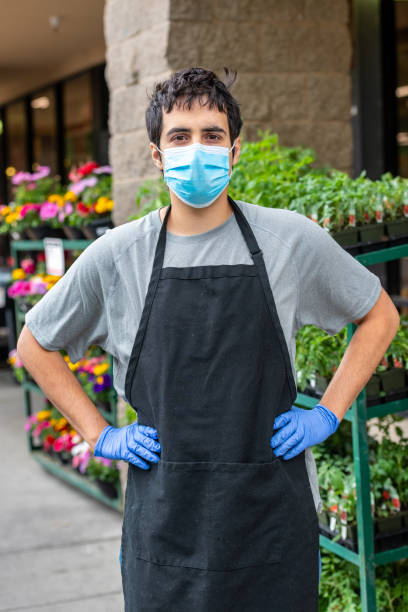 istock Hardware store and plant nursery worker posing with a protective mask 1224739792