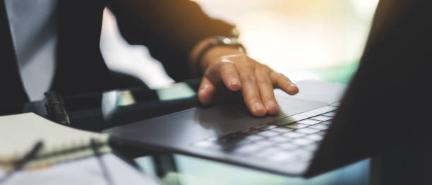 istock Businesswoman touching on laptop computer touchpad while working in office 1224740692