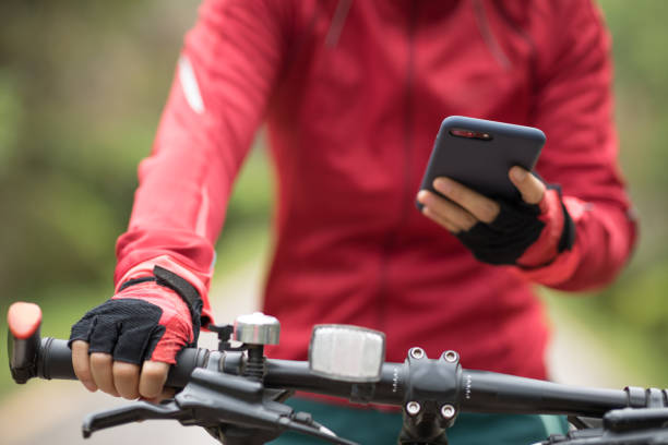 istock Cyclist use smartphone when riding mountain bike on forest trail 1224741666