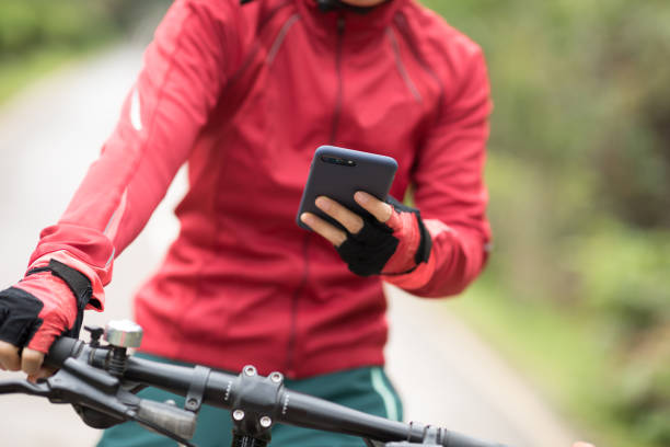 istock Cyclist use smartphone when riding mountain bike on forest trail 1224741690