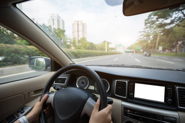 istock People hands holding steering wheel while driving car on city road 1224742070