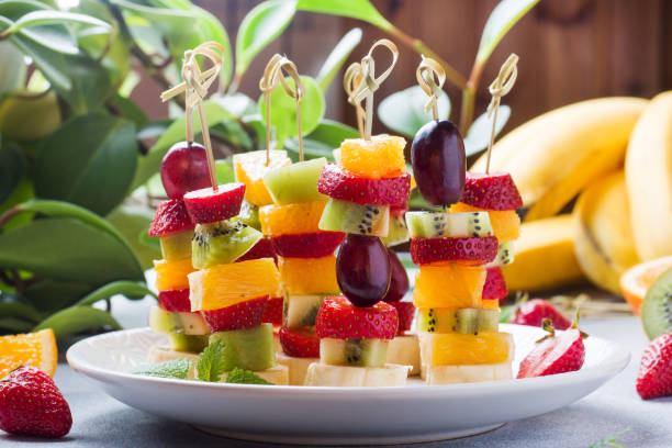 istock Fresh fruit on skewers. Concept buffet for a summer party. 1224743024