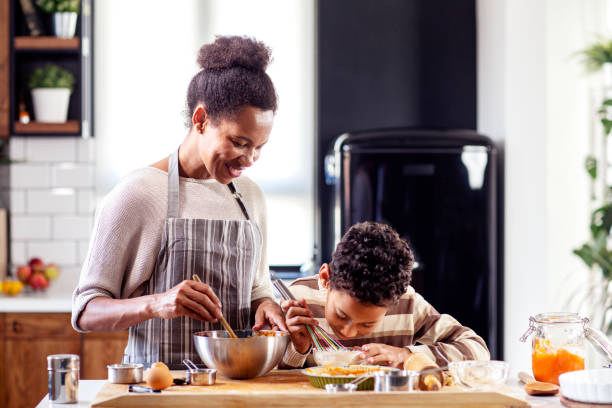 istock Woman prepare pie in the kitchen and learn his son cooking 1224744384