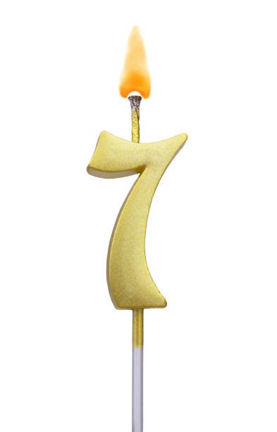 istock Burning golden birthday candle isolated, number 7 1224746096