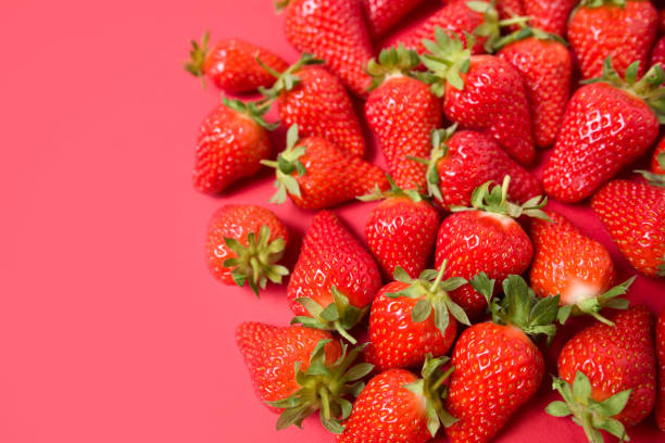 istock Ripe juicy orgaic strawberries on a red background. 1224747440