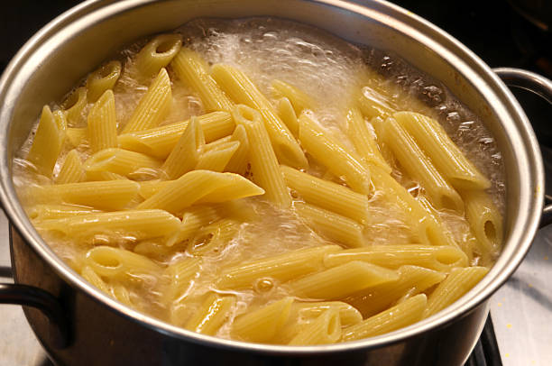 istock pot with boiling water and Italian pasta during cooking 1224748248