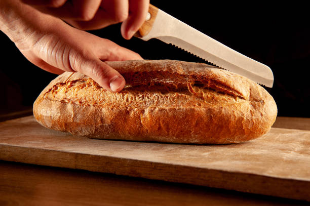 istock baked bread is cut with a knife 1224748699