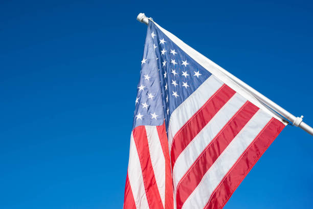 istock American flag in the blue sky. 1224749287
