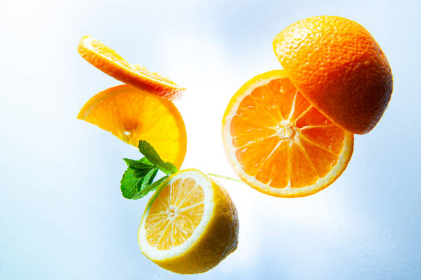 istock lemon, orange and mint on a light background top view and close up 1224749292