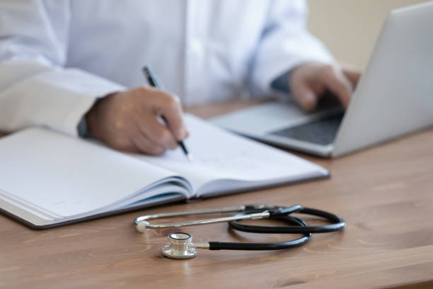 istock Senior doctor physician working with stethoscope on desk, closeup 1224749350