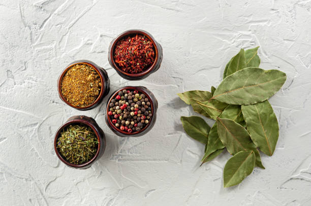 istock bay leaf, pepper and spice on white texture background top view 1224749852