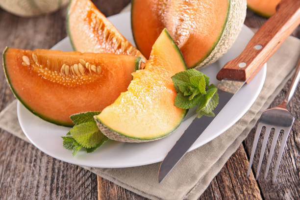 istock melon slices and mint on wood background 1224753060