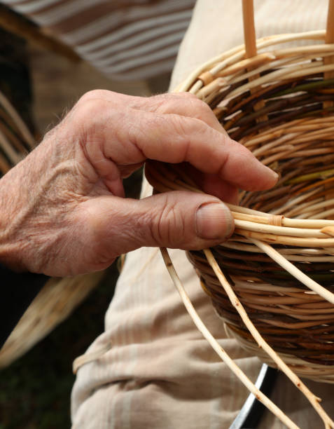 istock craftsman weaves a wicker basket 1224755365